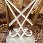 3D printed Sigil of Lucifer in silver on a round base, displayed outdoors against tree trunks and soil background