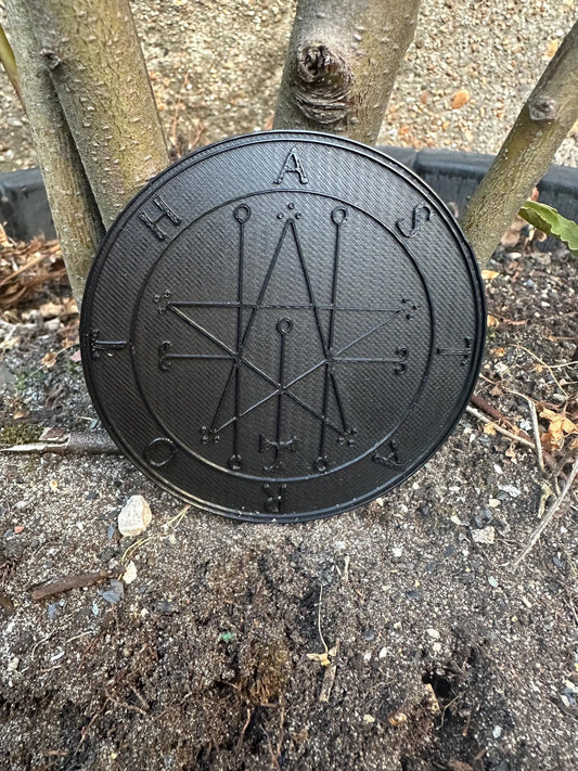 Matte black King Solomon’s Lesser Key Goetia seal ritual tool with intricate infernal sigil design.